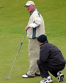 Some help from his caddie at the 18th